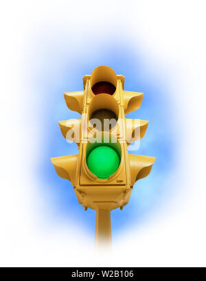 Upward view of tall vintage yellow traffic signal with green light on white vignette background Stock Photo