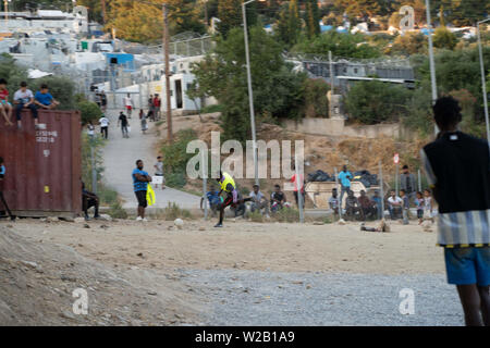 Samos, Samos, Greece. 28th June, 2019. Migrants from Cameroon and the Democratic Republic of Congo play football outside of Samos.Samos Island is one of Europe's migrant hotspots acting as a reception and identification centre (RIC). It was established as a temporary accommodation site where migrants could be processed before moving to a refugee camp on the mainland. However, due to the continued number of arrivals, the mainland camps are full and so migrants are being left at the islands. The conditions are inhuman as the Central Government has for several years ignored requests from the Stock Photo
