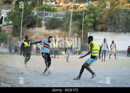 Samos, Samos, Greece. 28th June, 2019. Migrants from Cameroon and the Democratic Republic of Congo play football outside of Samos.Samos Island is one of Europe's migrant hotspots acting as a reception and identification centre (RIC). It was established as a temporary accommodation site where migrants could be processed before moving to a refugee camp on the mainland. However, due to the continued number of arrivals, the mainland camps are full and so migrants are being left at the islands. The conditions are inhuman as the Central Government has for several years ignored requests from the Stock Photo