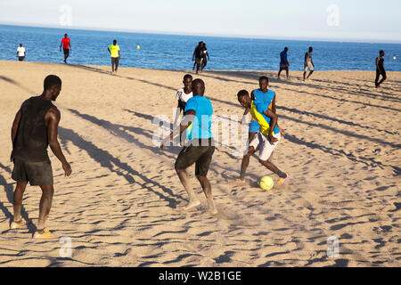 African men on the beach playing football Stock Photo