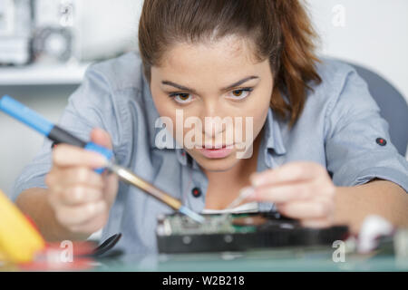 female worker doing assembly of electronic devices Stock Photo