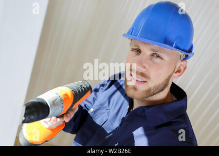 high-angle view of builder using cordless drill Stock Photo