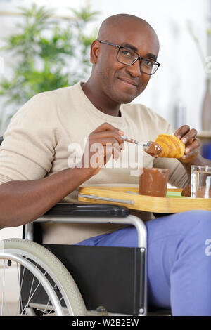 relaxed handsome man having breakfast Stock Photo