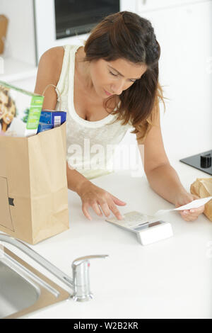 a woman calculates the expense Stock Photo