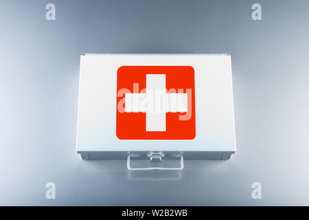 Tin first aid kit with cross emblems on grey background Stock Photo