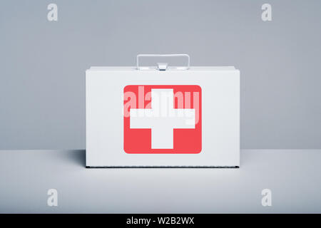 Tin first aid kit with cross emblem on grey background Stock Photo