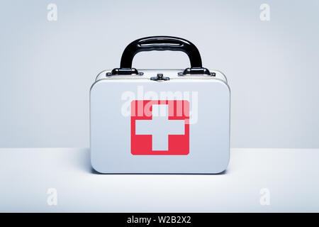 Tin first aid kit with cross emblem on grey background Stock Photo