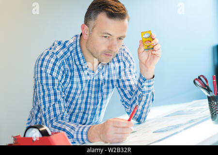 young creative male engineer making project on drawing board Stock Photo
