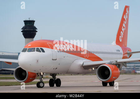 An Easyjet Airbus A320-200 taxis on the runway at Manchester Airport, UK. Stock Photo