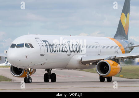 A Thomas Cook Airbus A321-200 taxis on the runway at Manchester Airport, UK. Stock Photo