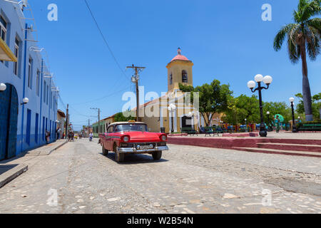 Trinidad, Cuba - June 6, 2019: View of an Old Classic American Car in the streets of a small Cuban Town during a vibrant sunny day. Stock Photo