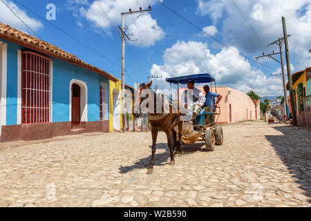 Trinidad, Cuba - June 6, 2019: Horse Carriage in the streets of a small Cuban Town during a vibrant sunny day. Stock Photo