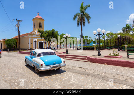 Trinidad, Cuba - June 6, 2019: View of an Old Classic American Car in the streets of a small Cuban Town during a vibrant sunny day. Stock Photo