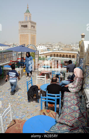 A rooftop view of the Tunis old city and medina overlooking the Zeitoun mosque and its minaret, seen from an outdoor cafe, Tunisia. Stock Photo