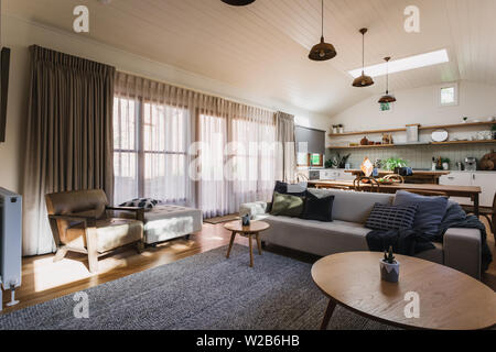 Open plan living, dining and kitchen in a country home with a vaulted ceiling Stock Photo