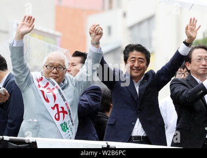 Tokyo, Japan. 7th July, 2019. Japanese Prime Minister and leader of the ruling Liberal Democratic Party (LDP) Shinzo Abe raises his hands with his party candidate Keizo Takemi (L) at a campaign for the July 21 Upper House election in Tokyo on Sunday, July 7, 2019. Credit: Yoshio Tsunoda/AFLO/Alamy Live News Stock Photo
