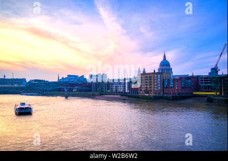 St. Paul's Cathedral across Millennium Bridge and the River Thames in London, UK. Stock Photo