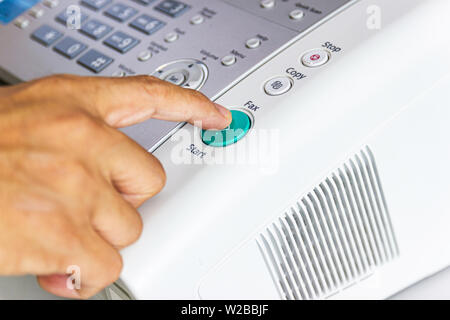 hand man are using a fax machine in the office Business concept Stock Photo