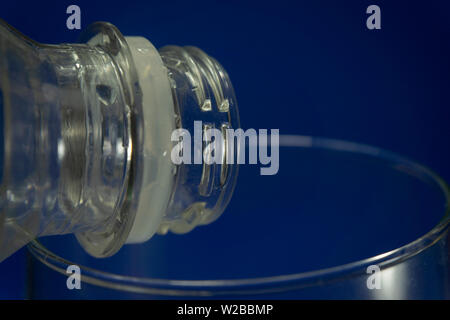 Close up of transparent white used plastic water bottle neck, recycling and food storage concept Stock Photo
