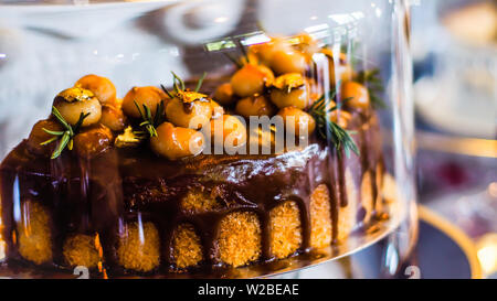 Delicious cake with peanut butter cream layer and chocolate topping. Bakery shop background. Selective focus Stock Photo