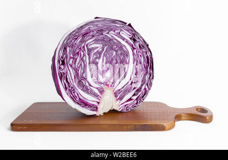 Purple cabbage cut in half on a wooden cutting board Stock Photo