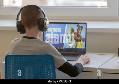 Vilnius, Lithuania - March 2, 2019: Child playing Fortnite game. Fortnite is popular online video game developed by Epic Games Stock Photo