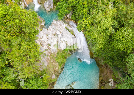 Beautiful waterfall in green forest, top view. Tropical Inambakan Falls in mountain jungle, Philippines, Cebu. Waterfall in the tropical forest. Pure water in the jungle. Stock Photo