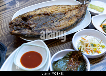 Korean food - Grilled mackerel with side dishes on the table Stock Photo