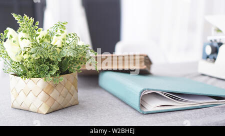 Female workspace with flowers bouquet on white background. Womens office desk. Stock Photo