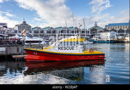 Cape Town, South Africa, 12th April - 2019: Waterfront harbour with yachts  moored and people in restaurants overlooking the water. Stock Photo