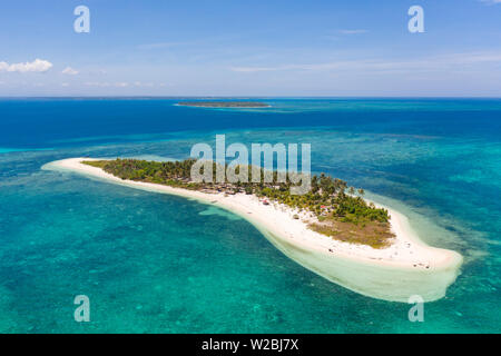 Tropical island Canimeran. White sandy beach on a desert island. Small island with palm trees and white sand. Stock Photo