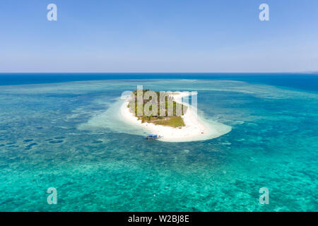 Tropical island Canimeran. White sandy beach on a desert island. Small island with palm trees and white sand. Stock Photo