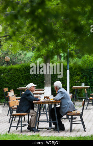 Albania, Korca, Birra Korca Brewery, most popular beer in Albania, men in beer garden Stock Photo