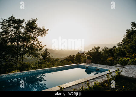 Swimming pool with panoramic views of the sunset or dawn Stock Photo