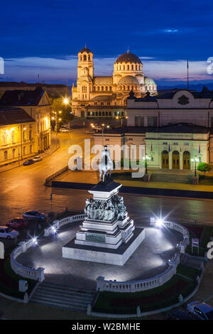 Bulgaria, Sofia, Ploshtad Narodno Sabranie Square, Statue of Russian Tsar Alexander II, National Assembly building, and Alexander Nevski Cathedral, elevated view, dusk Stock Photo