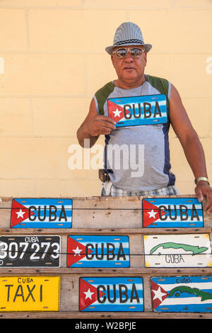 Cuba, Trinidad, Man selling Cuban car number plates Stock Photo