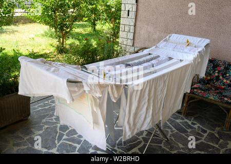 Laundry Drying on a Clothes Rack Stock Photo