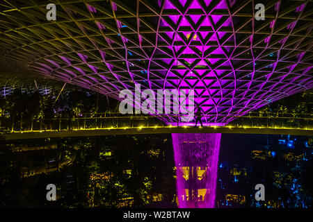 Singapore - Jun 11,  2019: Canopy Bridge walk just beside HSBC Rain Vortex at Night. Stock Photo