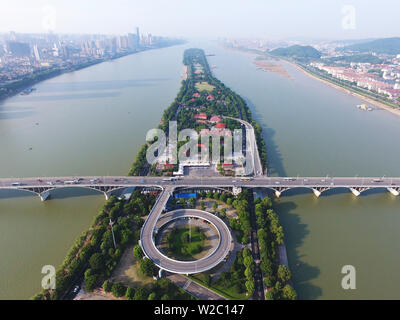 (190708) -- BEIJING, July 8, 2019 (Xinhua) -- Aerial photo taken on July 15, 2017 shows the Juzizhou Islet in the Xiangjiang River in Changsha, capital of central China's Hunan Province. Located in central China, Hunan Province is well-known for its varied topography. It abuts the Dongting Lake to the north, and the east, south and west sides of the province are surrounded by mountains, with Wuling and Xuefeng Mountains to the west, Nanling Mountain to the south, Luoxiao and Mufu Mountains to the east. The Xiangjiang, Zijiang, Yuanjiang and Lishui Rivers converge on the Yangtze River at the Do Stock Photo