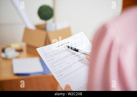 Close-up image of businesswoman reading employment contract and checking details Stock Photo