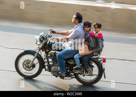 People on Royal Enfield Motorbike along Marine Drive, Mumbai, India Stock Photo