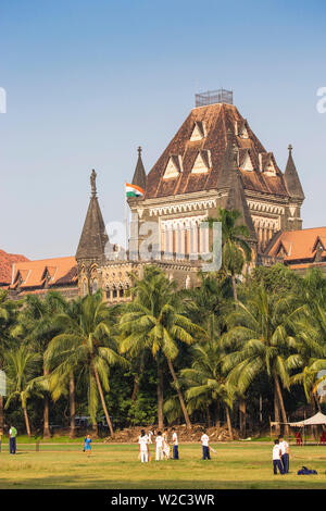 India, Maharashtra, Mumbai, Fort area, Children playing cricket in the Oval Maiden, with Bombay High Court behind Stock Photo