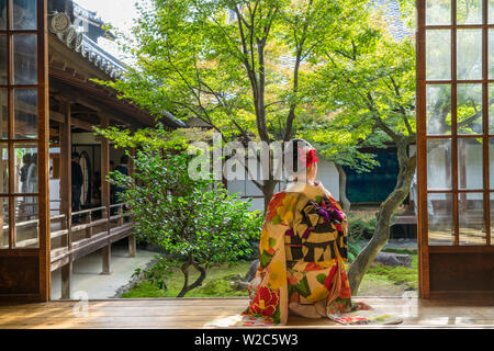 Woman looking out onto Zen garden, Kyoto, Japan Stock Photo