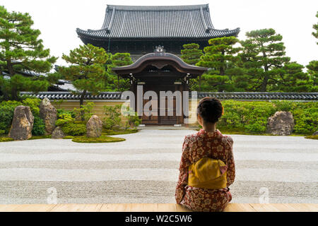 Woman looking out onto Zen garden, Kyoto, Japan Stock Photo