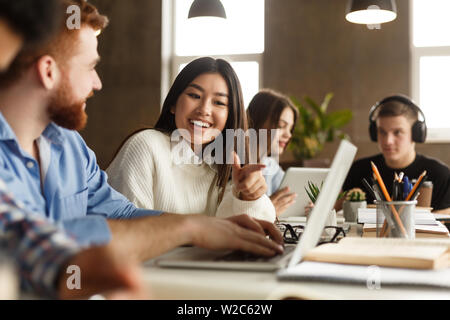 College students using laptop in library, studying Stock Photo