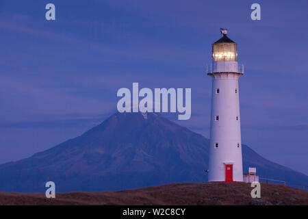 New Zealand, North Island, New Plymouth-area, Pungarehu, Cape Egmont Lighthouse and Mt. Taranaki, dusk Stock Photo