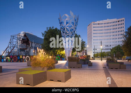 New Zealand, South Island, Christchurch, Cathedral Square, Chalice, sculpture by Neil Dawson, 2001 and building damaged in 2011 earthquake with ruins of Christchurch Cathedral, dusk Stock Photo