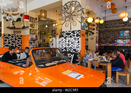 Romania, Crisana Region, Oradea, Lactobar, retro-bistro restaurant, interior with Romanian Dacia car Stock Photo