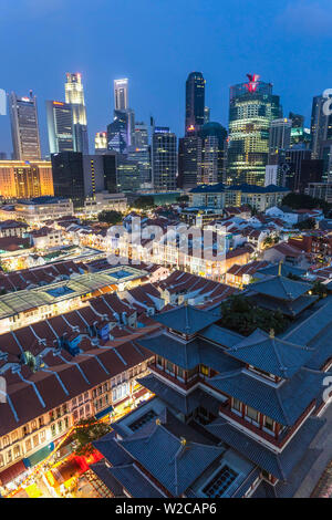 View over Buddha Tooth Relic Temple & city skyline at dusk, Chinatown, Singapore Stock Photo
