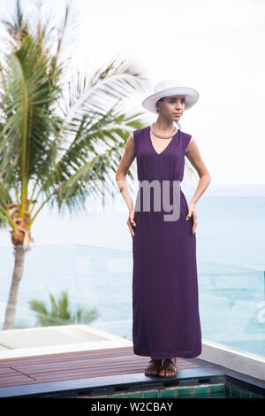 Woman in dress and hat, Koh Samui, Thailand Stock Photo